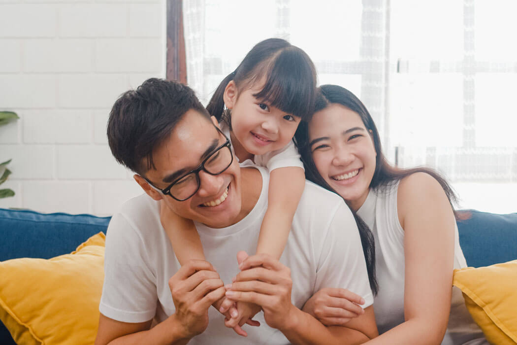 dad, mom, and daughter having fun and laughing