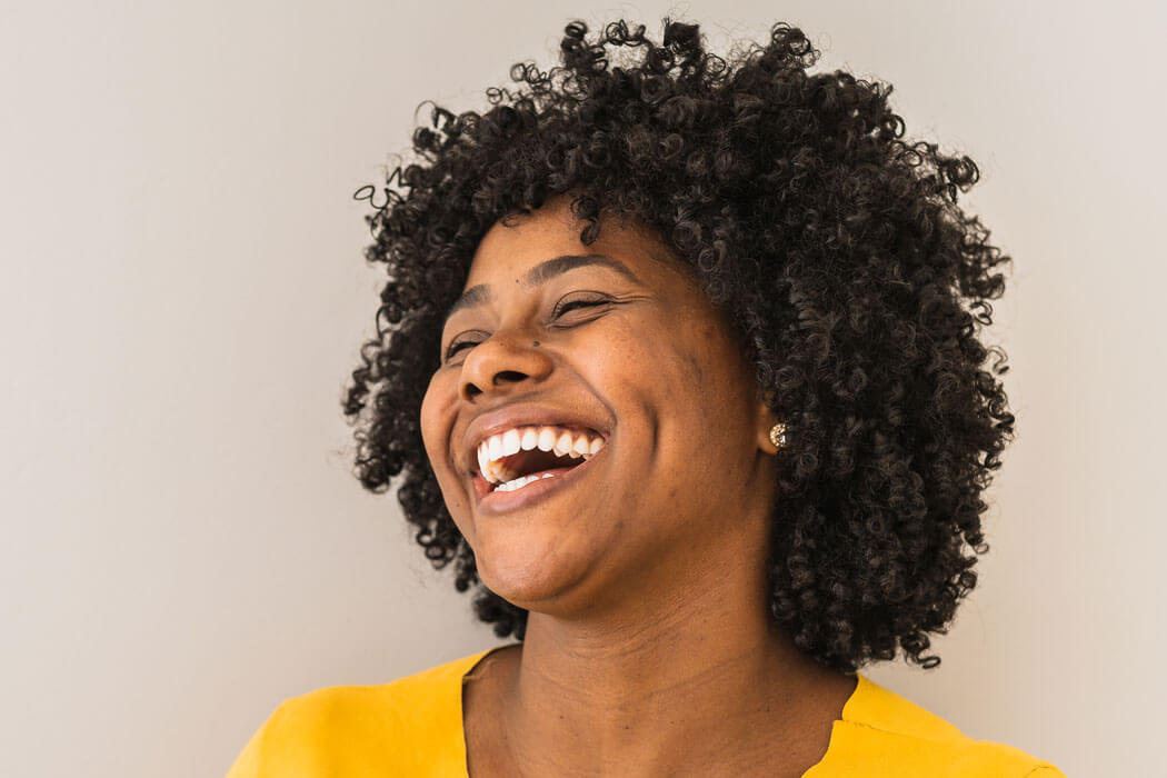 young woman with perfect teeth laughing