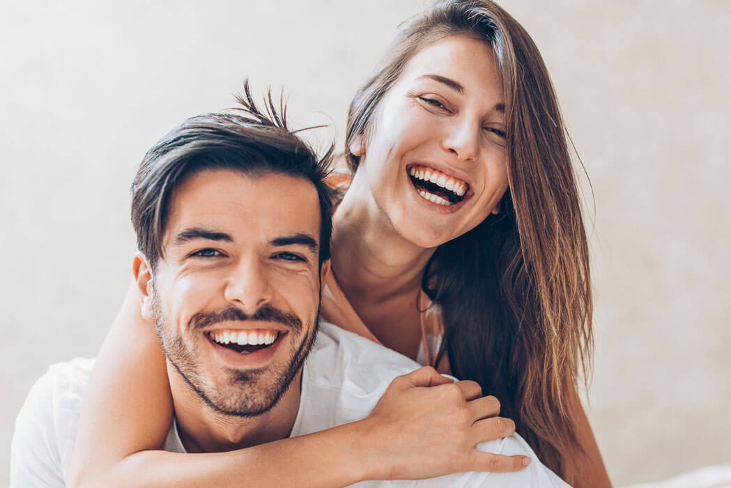 happy young couple with beautiful smiles