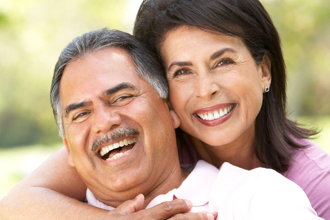 senior couple smiling in a park